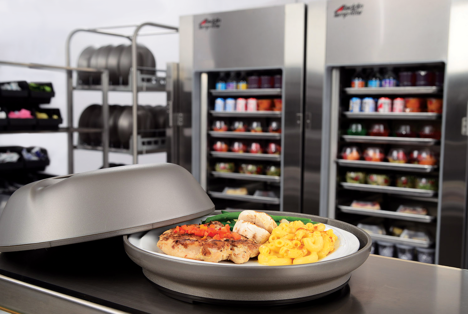 A nutritious meal plated at just the right temperature in front of hospital refrigerators.